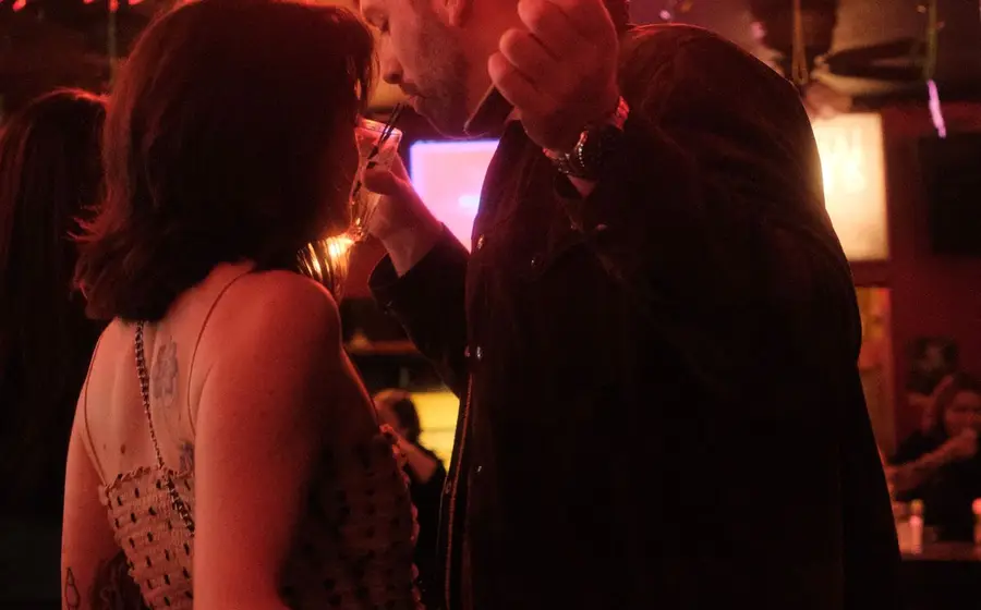 Couple at a karaoke bar in warm red light