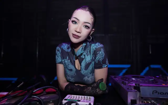DJ in a cheongsam performing at a nightclub