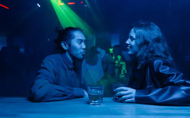 Conversation over drinks in a dim nightclub